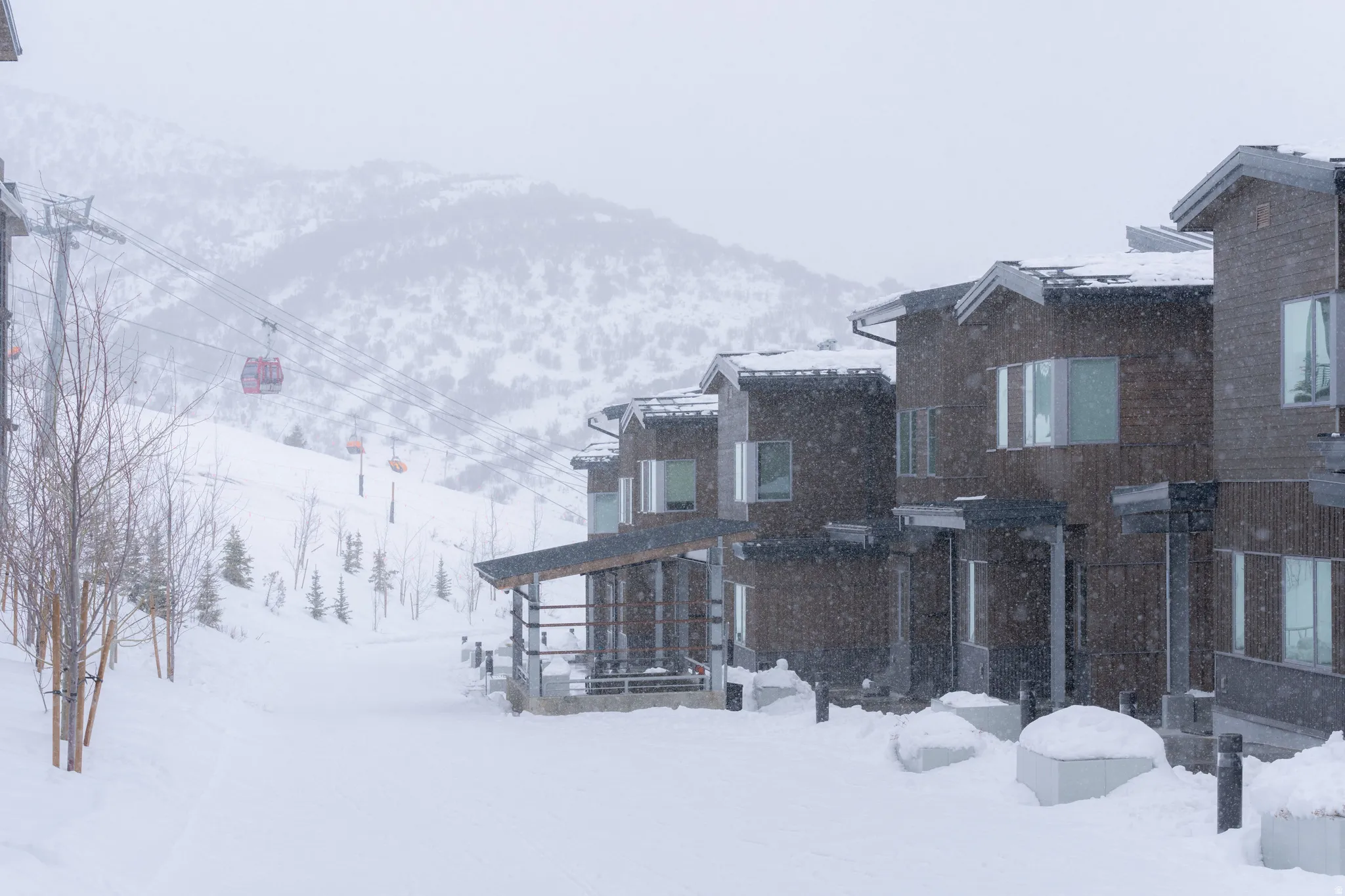 Modern multi-story residences featuring dark wood siding and gabled rooflines