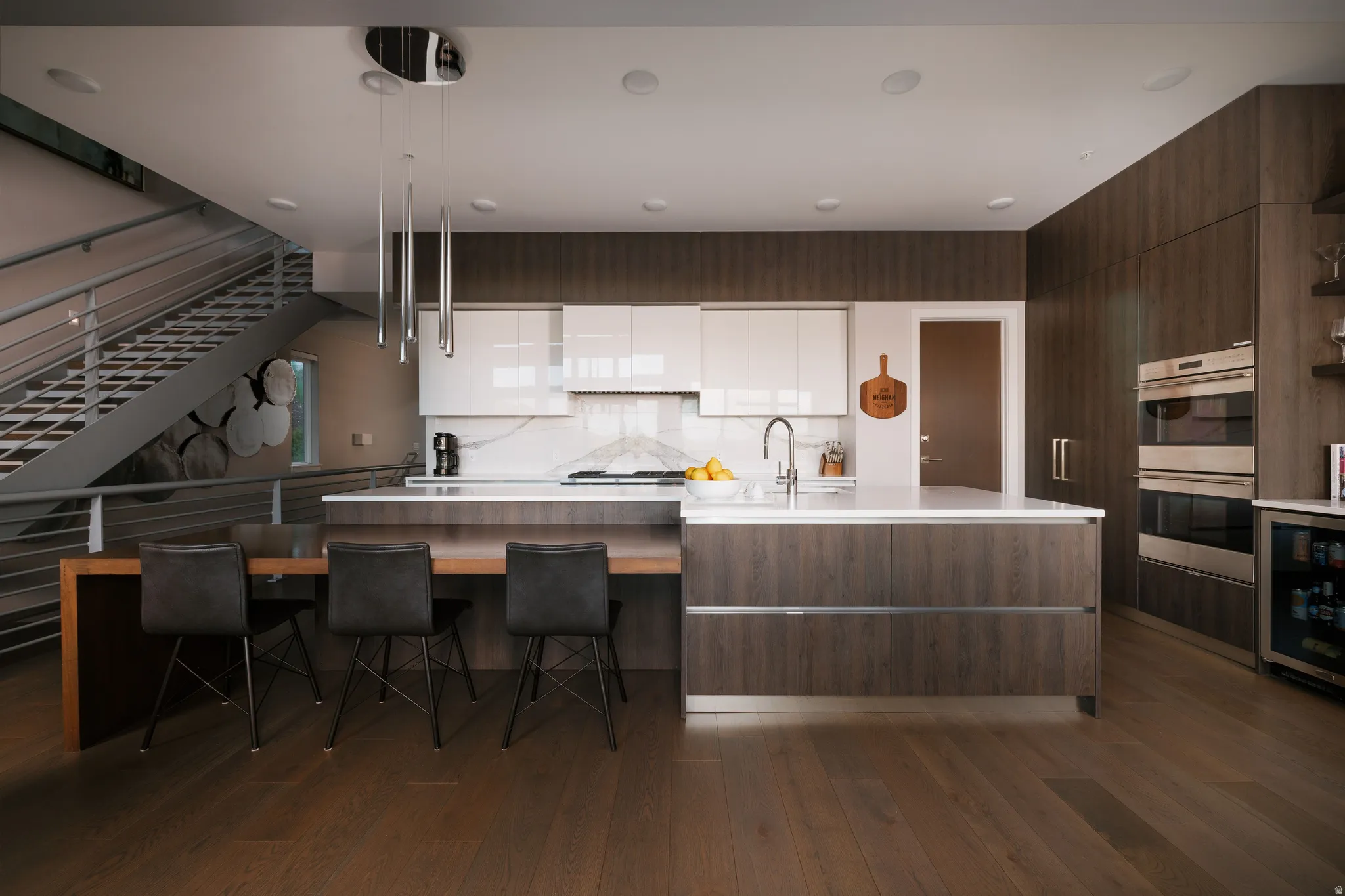 Contemporary kitchen featuring wood-finish flooring and extensive cabinetry