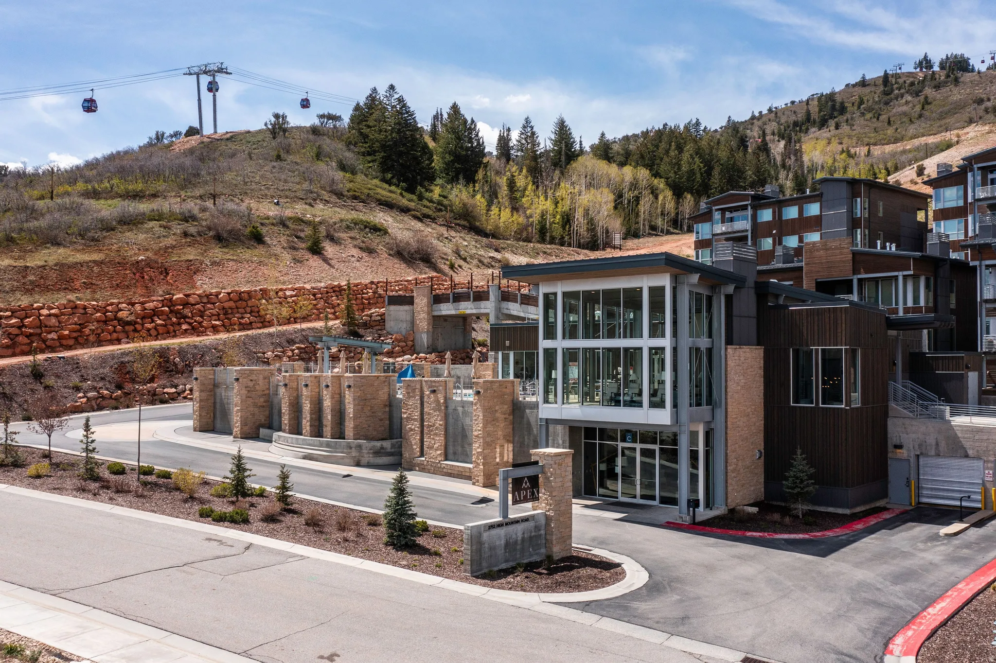 Contemporary architectural design featuring extensive glazing, wood-finish siding, and stone accents