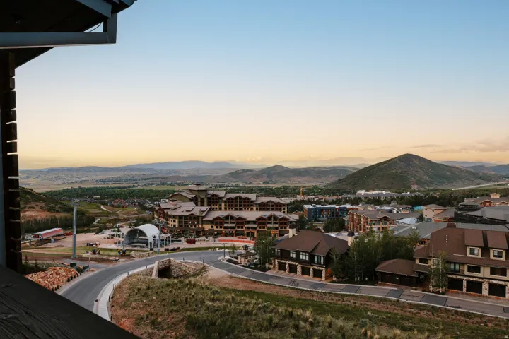 Elevated perspective showcasing a mountain backdrop and a developed community with varied architectural styles