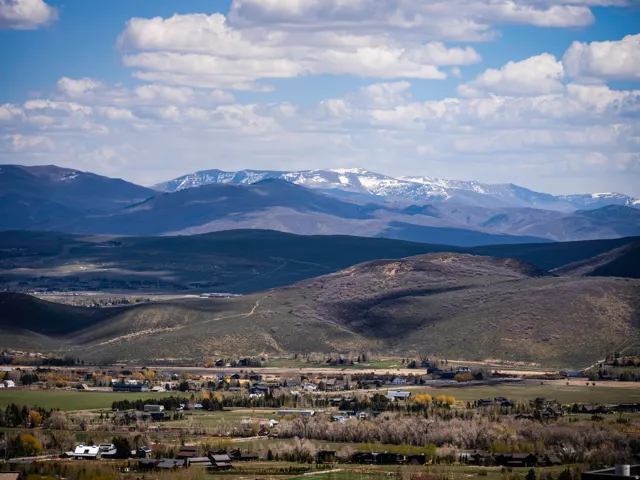 Expansive mountain range backdrop with distant snow-capped peaks
