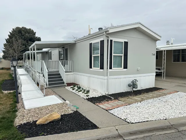 Light gray exterior with white trim and black shutters
