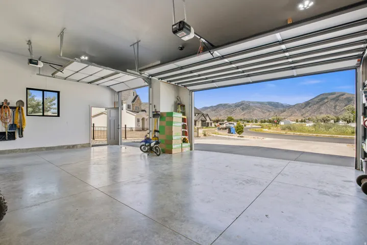 Spacious garage with smooth concrete flooring and overhead lighting