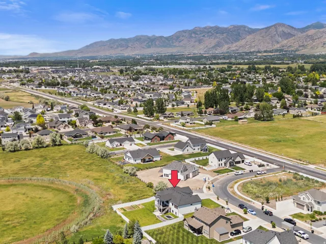 Aerial perspective showcasing a residential neighborhood with mountain backdrop