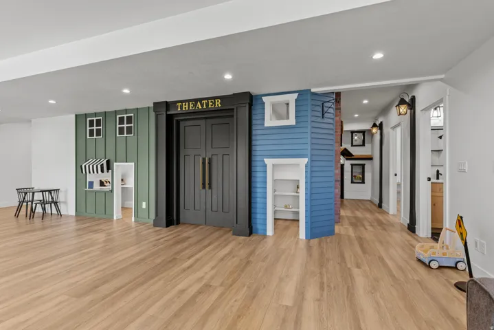 Expansive open-concept room featuring light wood-finish flooring, recessed lighting, and white walls