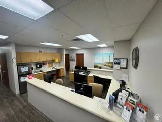Reception area featuring a built-in counter, wood-finish flooring, and recessed ceiling lighting