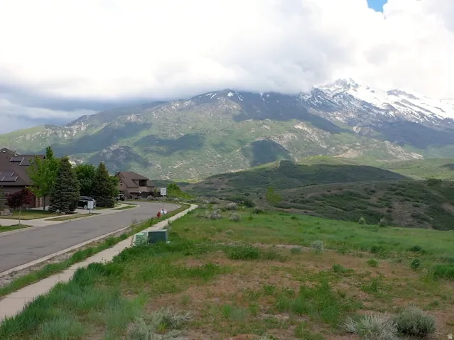 Expansive natural landscape featuring rolling hills and distant snow-capped mountains