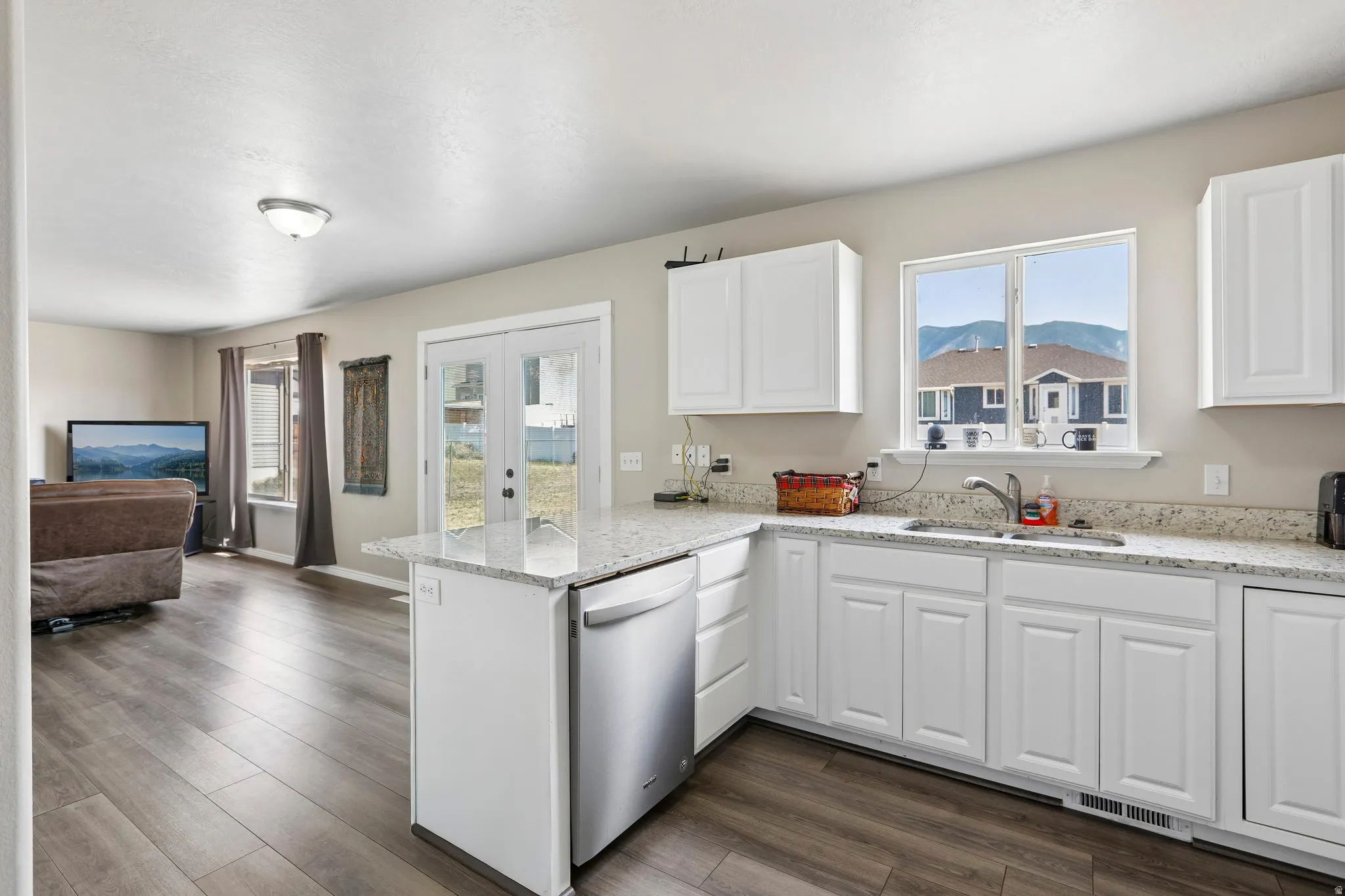 Modern kitchen featuring white cabinetry and light-toned countertops
