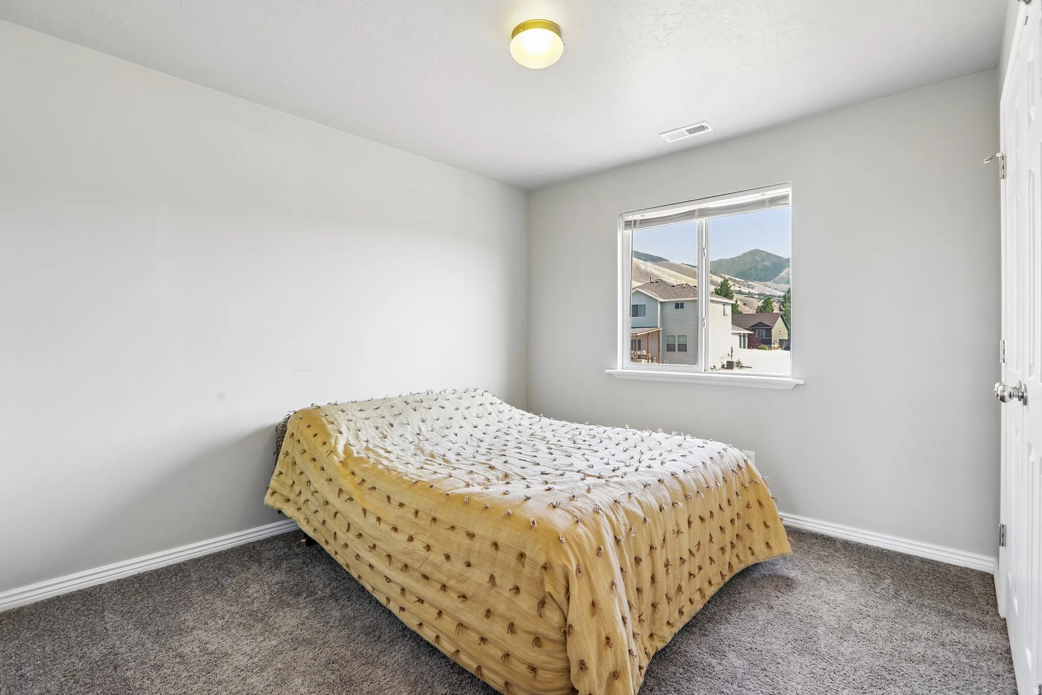 Room with neutral gray walls and gray carpet flooring