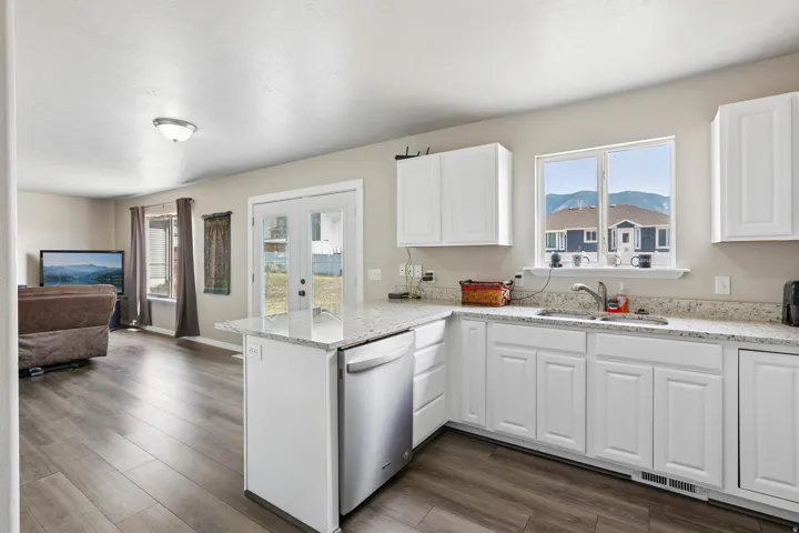Modern kitchen featuring white cabinetry and light-toned countertops