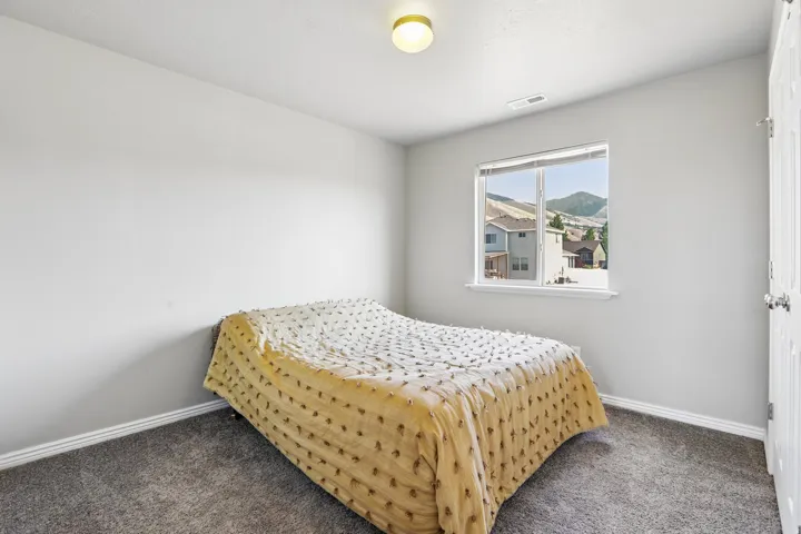 Room with neutral gray walls and gray carpet flooring