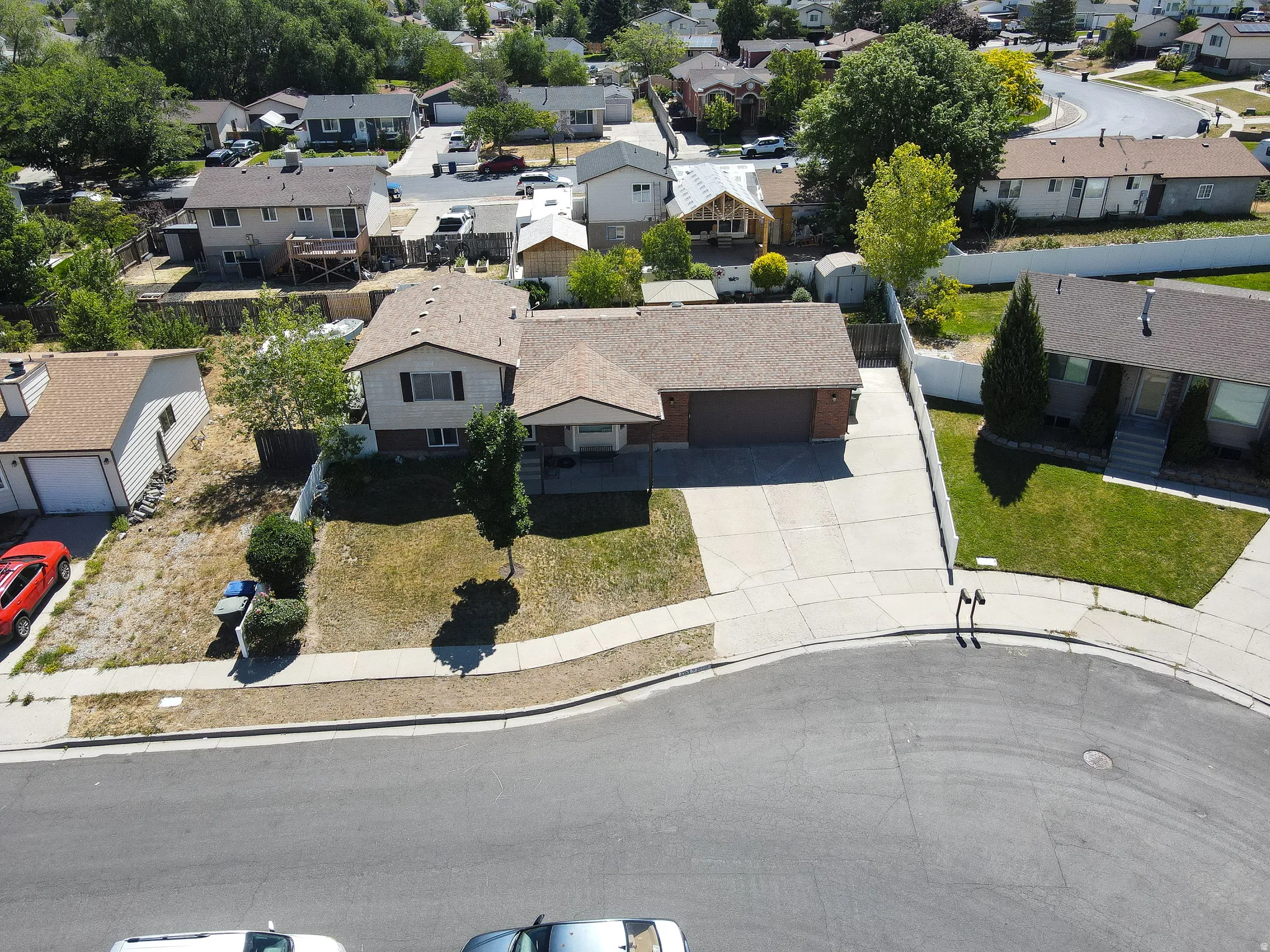 Single-story dwelling with an attached garage, a paved driveway, and a front lawn