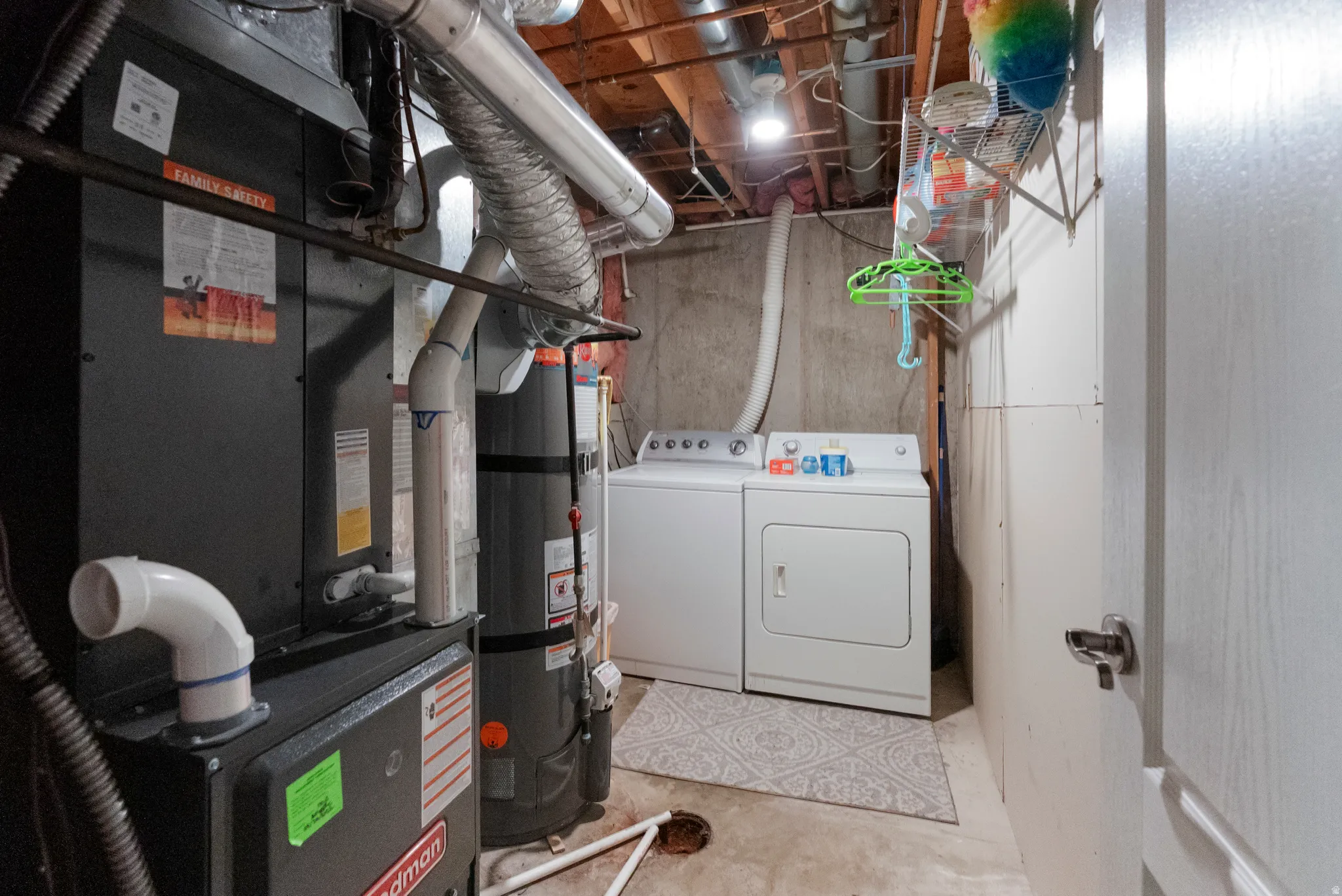 Dedicated utility space featuring a washer and dryer set, water heater, and furnace