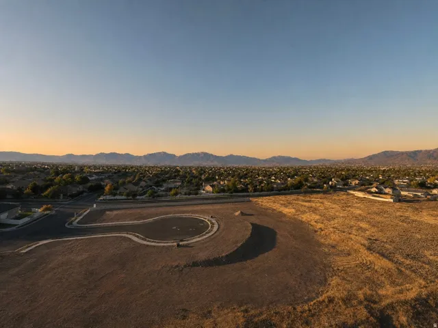 Expansive land parcel featuring paved cul-de-sac and desert landscaping