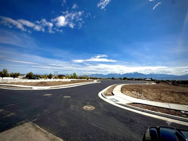 Newly paved road system with integrated sidewalks and curb cuts