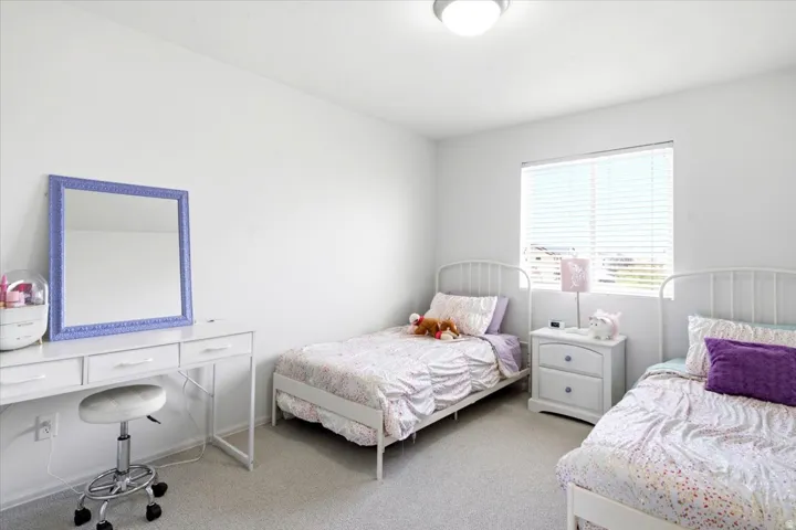 Bright interior space featuring white walls and light-toned carpeting