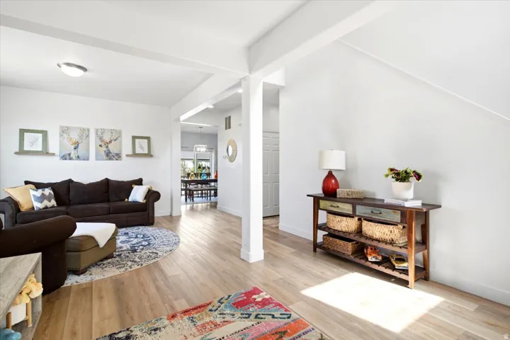 Open-concept living area with light wood-finish flooring