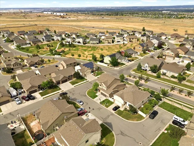 Expansive residential neighborhood featuring single-family homes with pitched roofs and attached garages