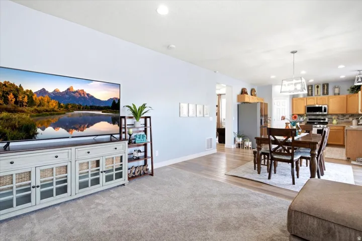 Open-concept living area featuring light-colored walls and recessed lighting