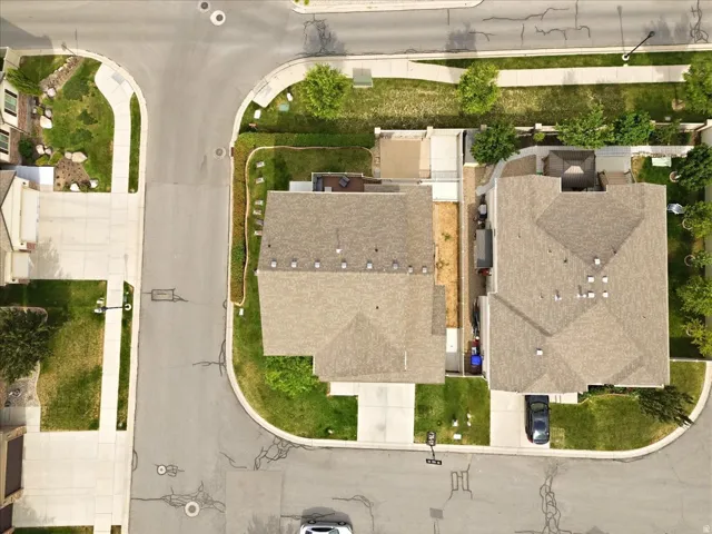 Residential property featuring an asphalt shingle roof and an attached concrete driveway