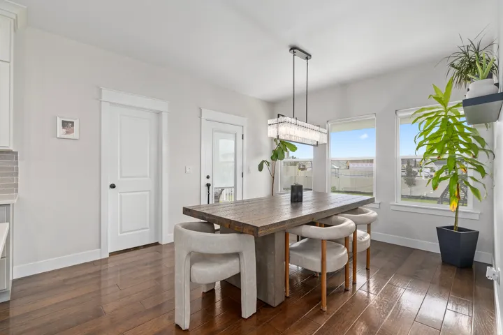 Dining area featuring a chandelier, dark wood-style floors, and recessed lighting.