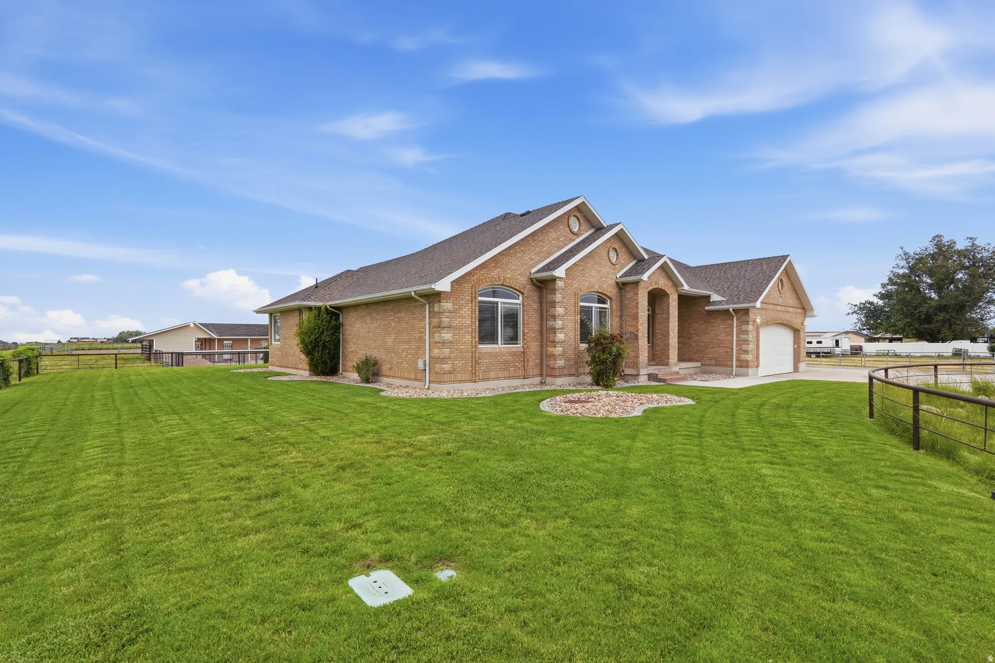 Brick exterior residence featuring an attached garage and a concrete driveway
