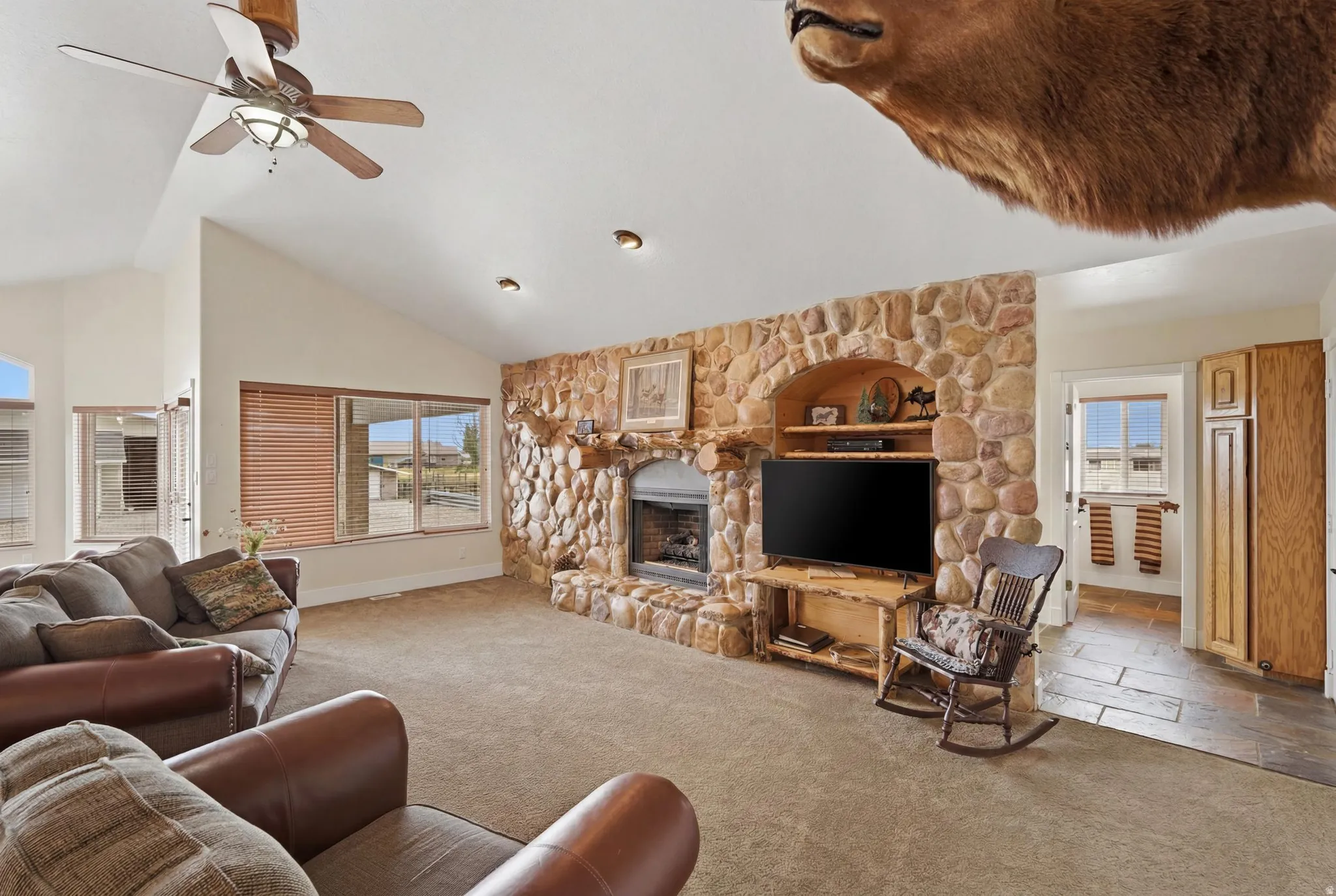 Vaulted ceiling with an overhead fan and recessed lighting