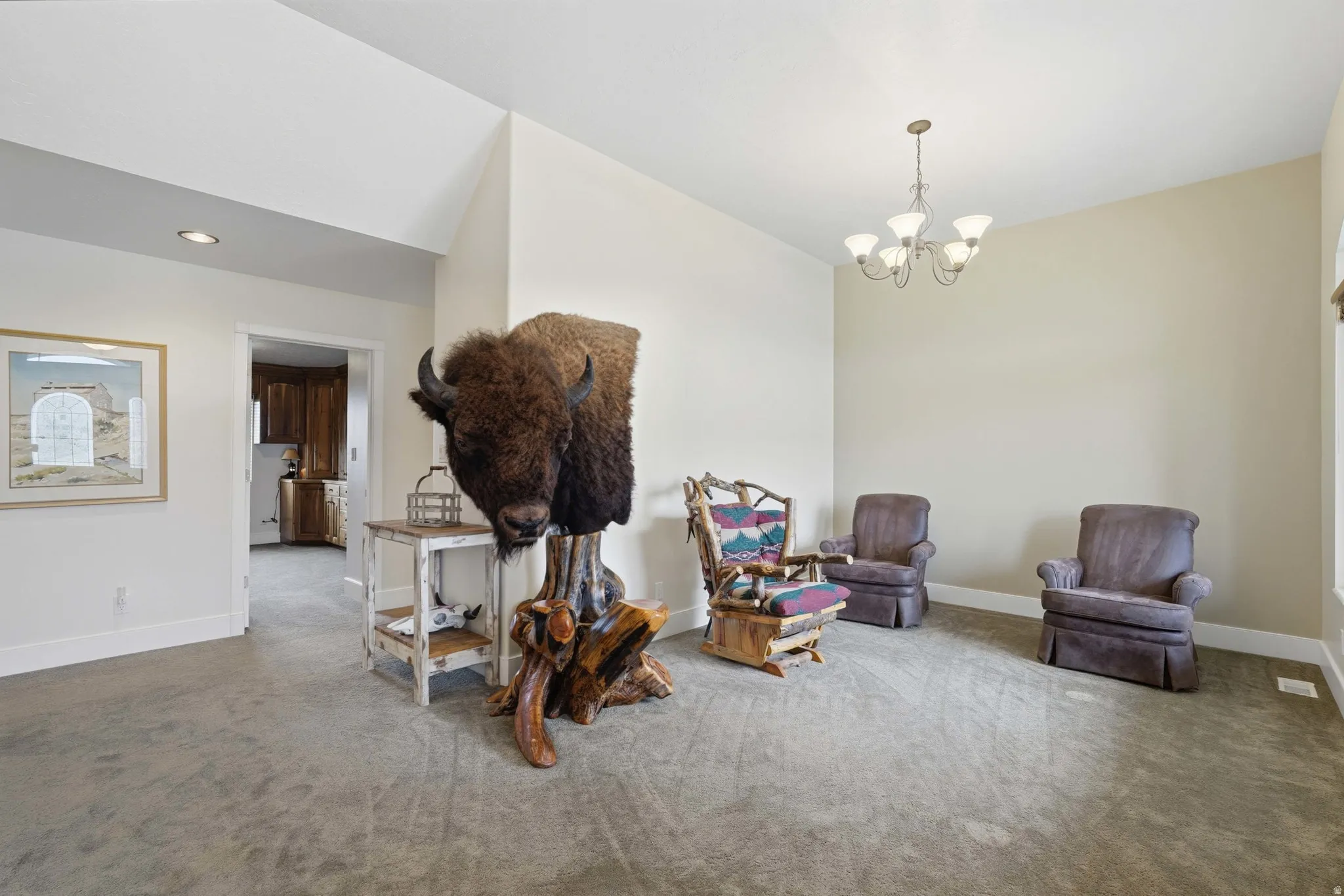 Spacious interior featuring a vaulted ceiling and neutral wall tones