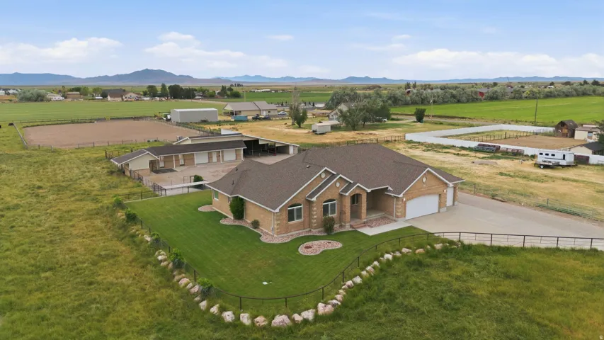 Ranch-style residence featuring a prominent front entrance, attached two-car garage, and a large paved driveway