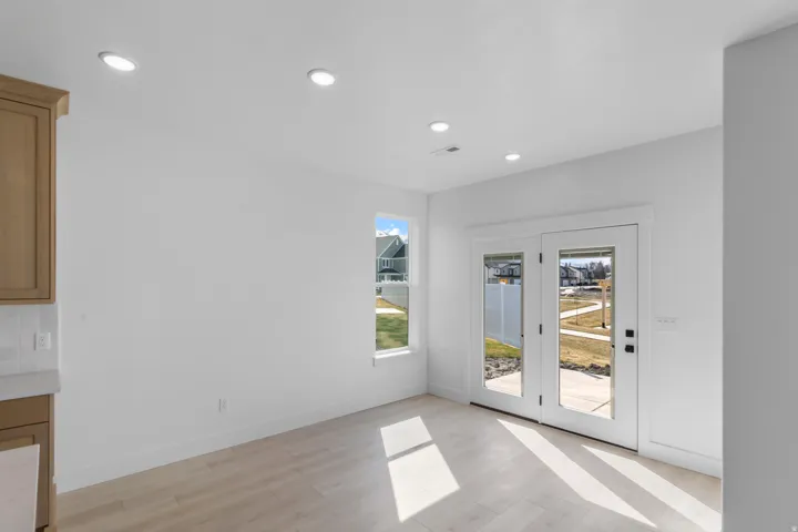 Bright interior space featuring light wood-finish flooring, recessed lighting, and white walls
