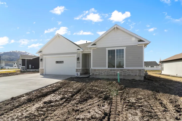 Contemporary single-story residence featuring light gray siding and white trim