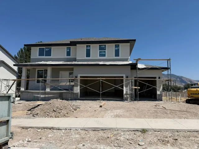 Contemporary two-story residence featuring light stucco exterior and dark trim