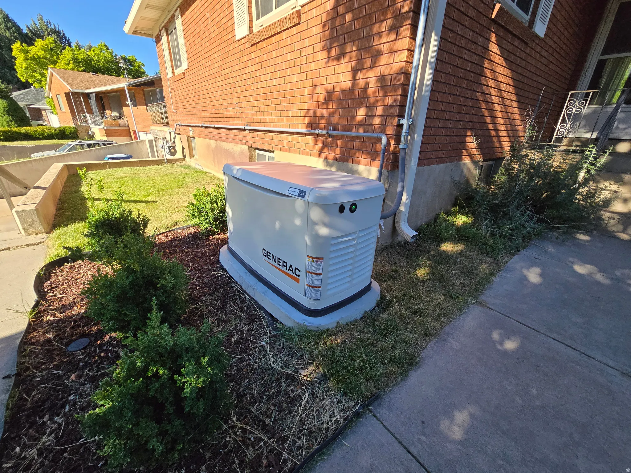 Generac whole-home generator unit positioned on a concrete pad