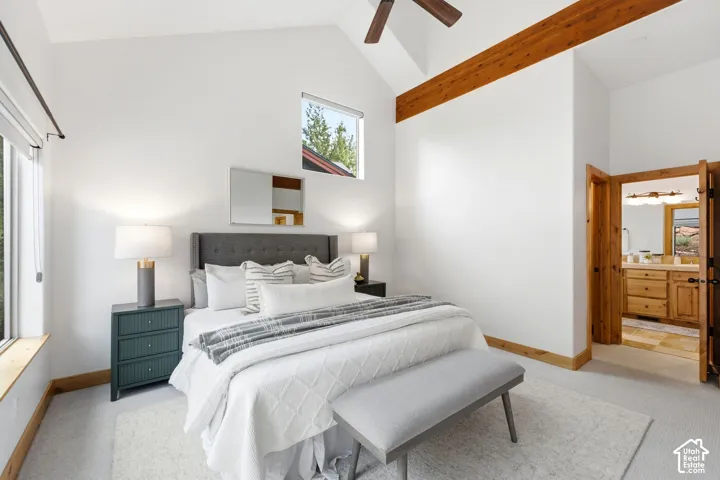 Vaulted ceiling with exposed wood beam and ceiling fan