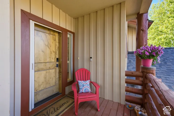 Inviting wood-finish entry door with a sidelight, framed by rich trim