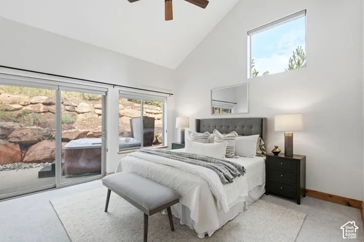 Vaulted ceiling with wood-finish ceiling fan, complemented by a high rectangular window