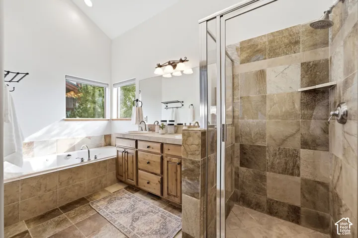 Ceramic tile flooring and a spacious walk-in shower with glass enclosure