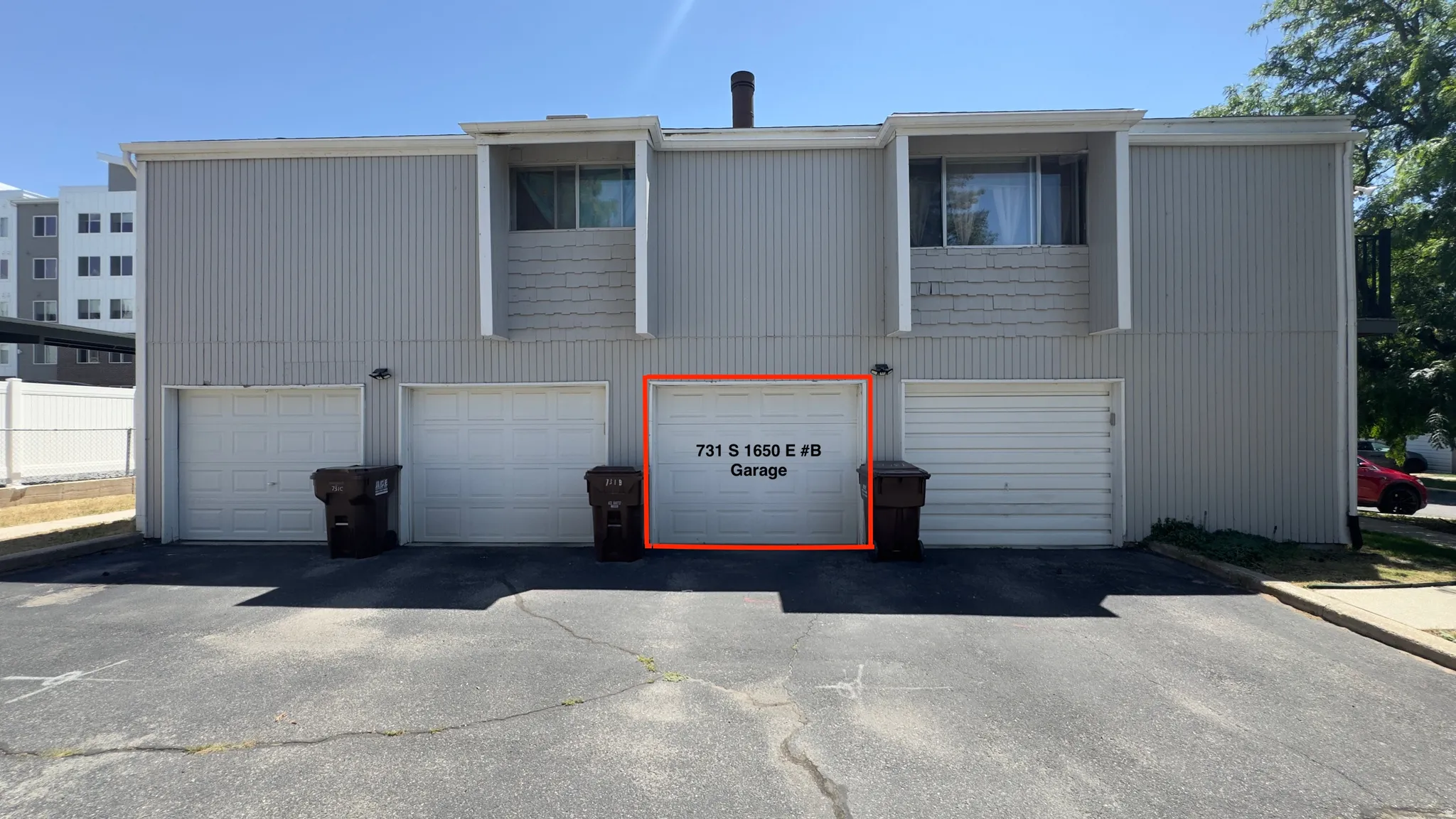 Individual garage stall featuring a roll-up door and direct access from the paved parking area.