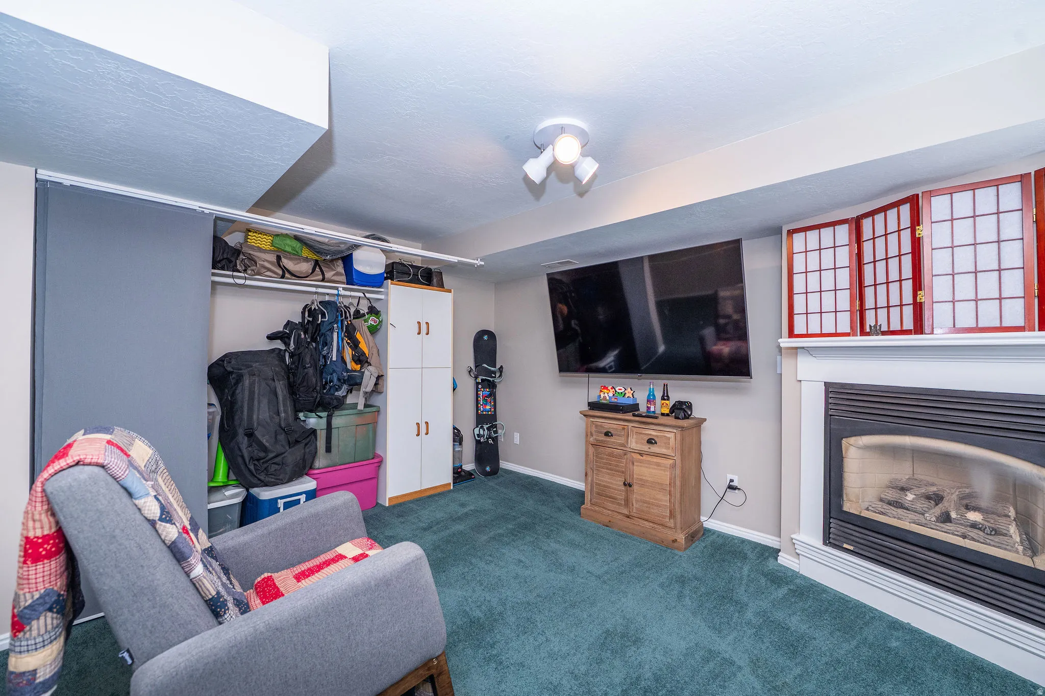 Living room or additional bedroom space features gas fireplace