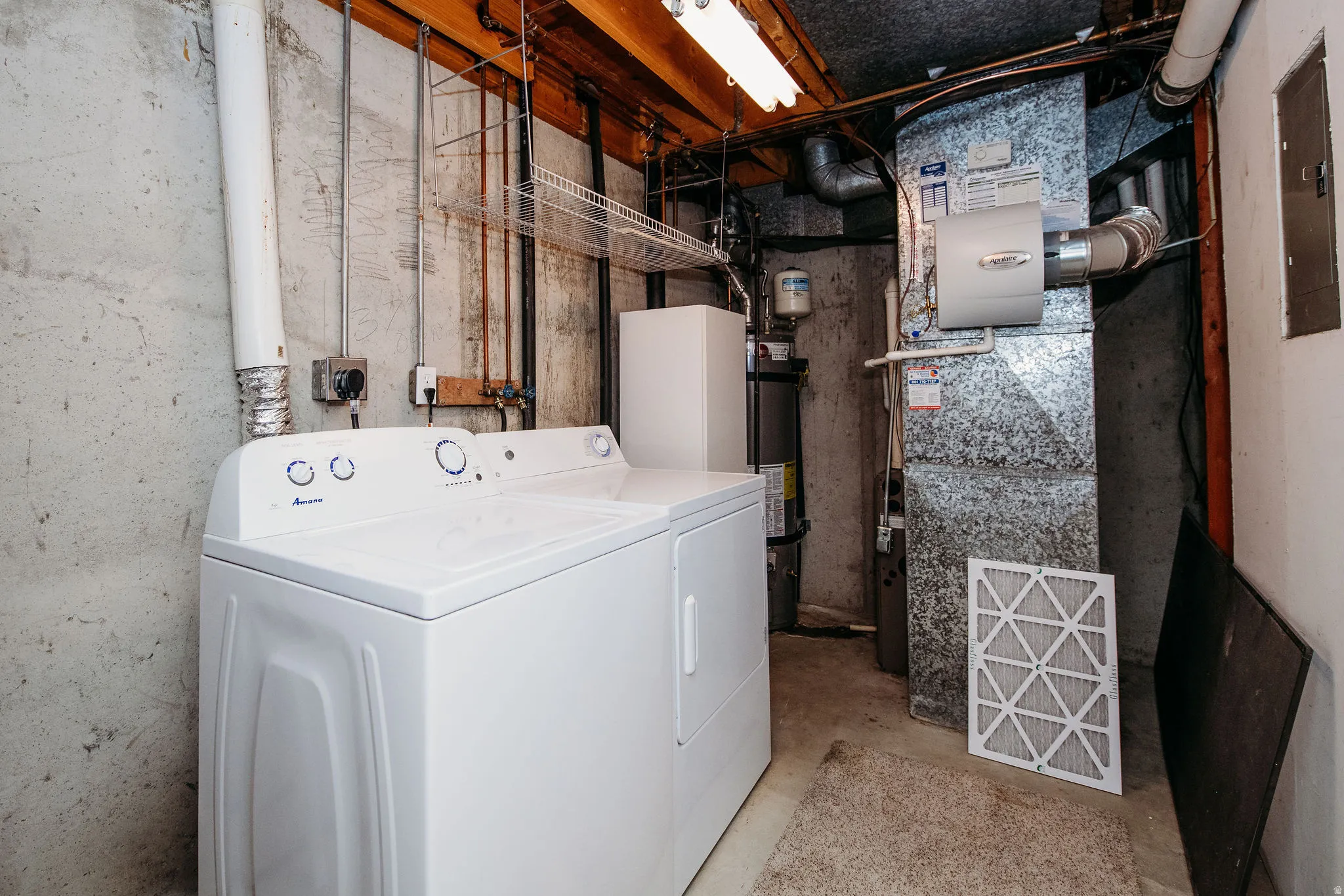 Dedicated laundry area with a top-load washer and dryer