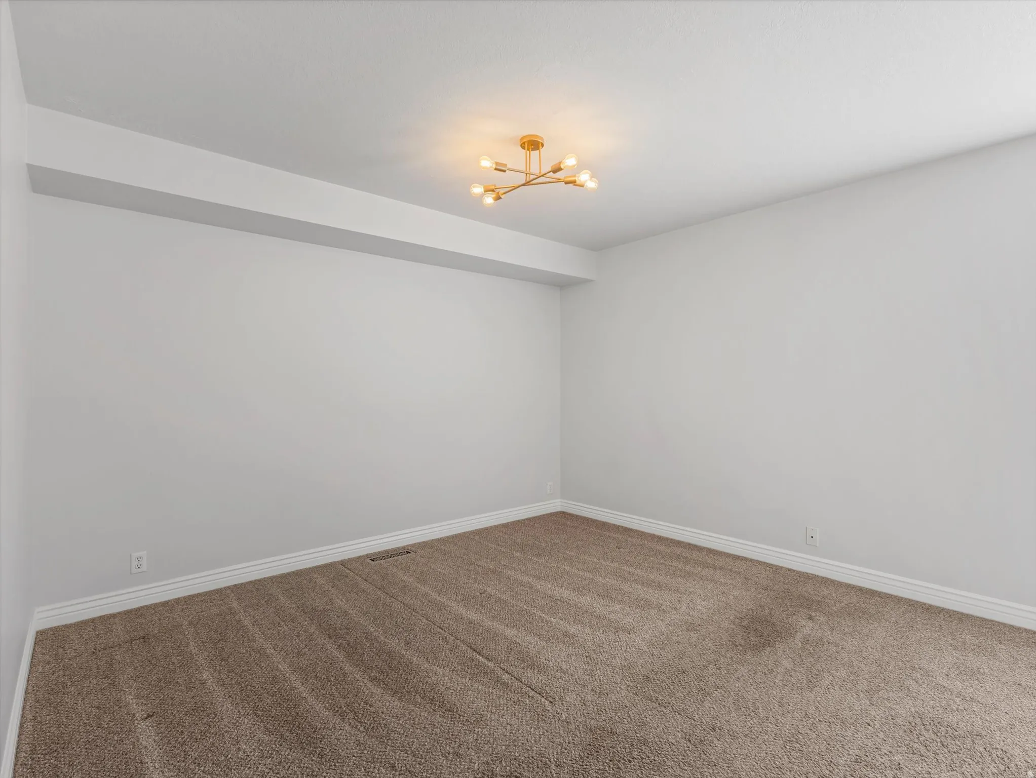 Neutral-toned carpeting paired with white baseboards