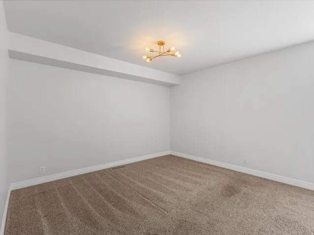 Neutral-toned carpeting paired with white baseboards