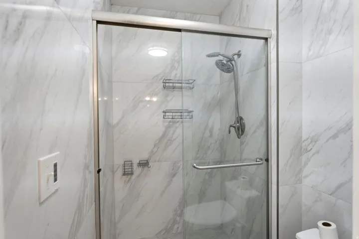 Primary bedroom suite bathroom with updated shower