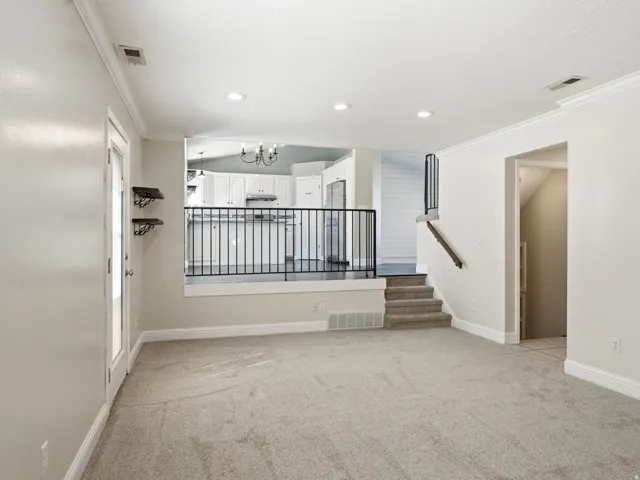Family room off kitchen with new carpet-walks out to back yard and access to laundry room and guest bathroom