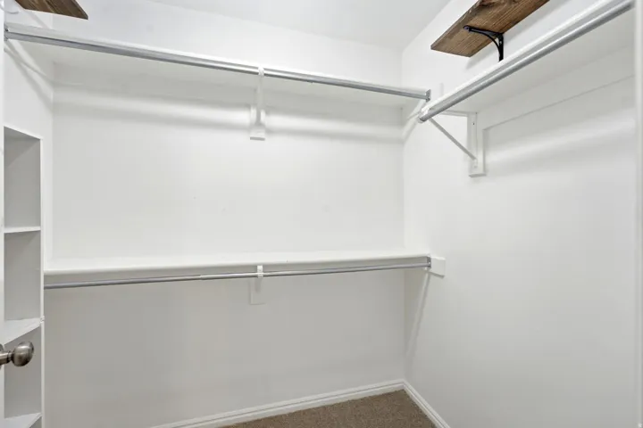 Primary bedroom walk-in closet