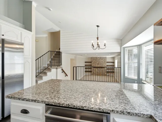 Kitchen island with granite countertop-view of dining area and main level family room