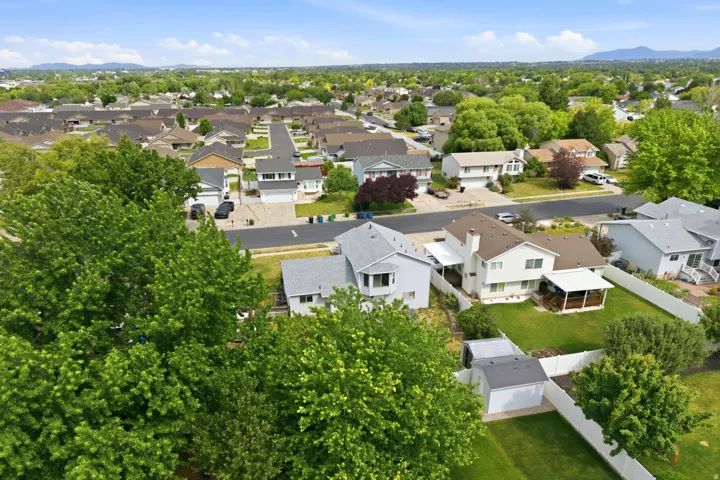 Suburban neighborhood featuring detached homes with varied architectural styles and established landscaping