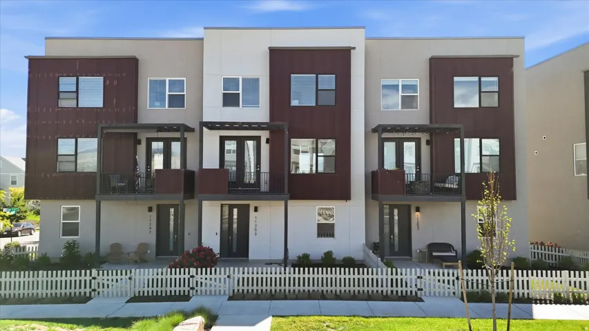 Modern multi-level townhome featuring a contemporary facade with varying material finishes