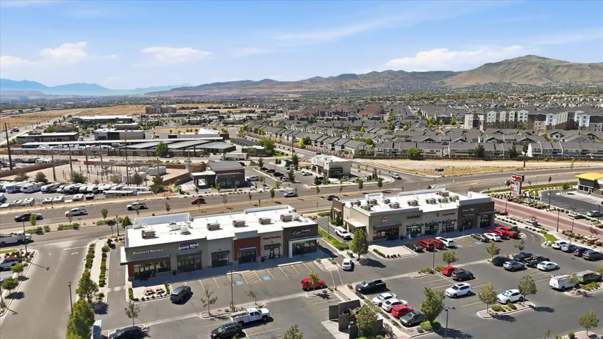 Commercial center featuring multiple storefronts, ample surface parking, and a prominent street-facing presence
