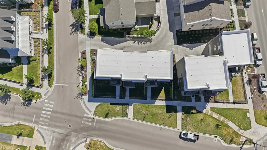 Aerial perspective showcasing a collection of modern townhome-style residences with flat roofs and individual balconies